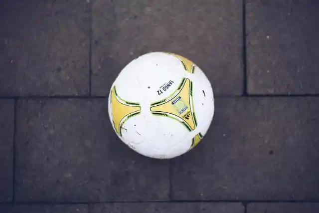 You see a ball lying on the sidewalk. What do you do?