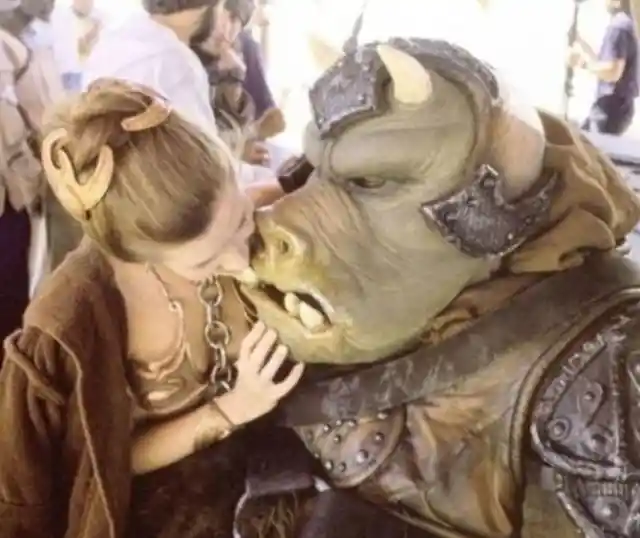 Carrie Fisher poses with a Gamorrean guard.