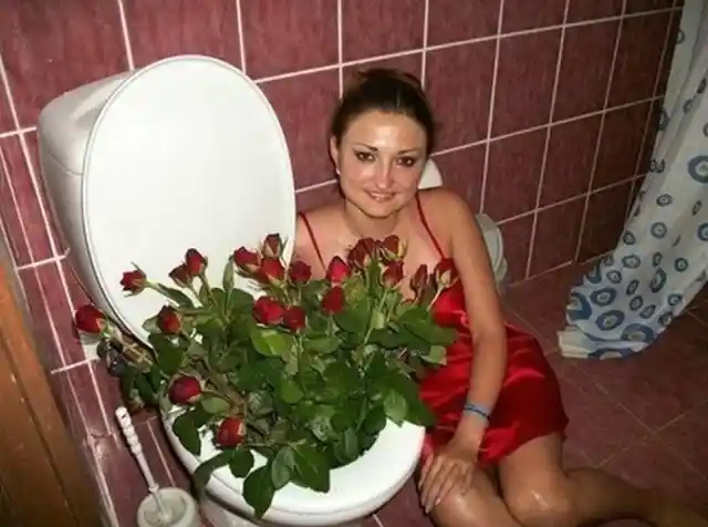 Woman with a bouquet of roses in the toilet