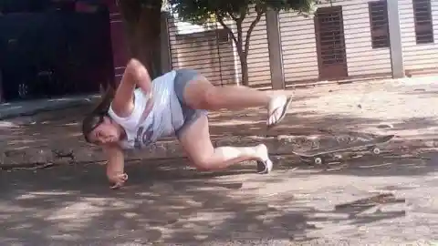 Woman falling off skateboard