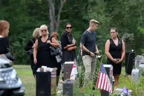 Mourners watch during the graveside service for Vanessa Marcotte at Woodside Cemetery Tuesday