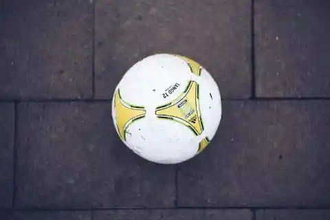 You see a ball lying on the sidewalk. What do you do?