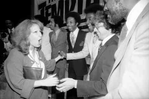 In 1977, The Temptations threw a party celebrating their signing with Atlantic Records. Pictured here is Bette Midler congratulating the Temptations at the party.