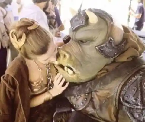 Carrie Fisher poses with a Gamorrean guard.
