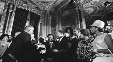 19. Lyndon B. Johnson shakes hands with Martin Luther King after the signing of the Voting Rights Act, 1965.
